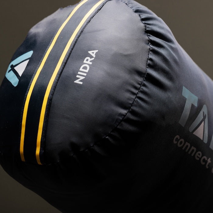 Dunkelblauer Mumienschlafsack NIDRA 1450 von Tambu Outdoor, Nahaufnahme der Kopfpartie mit Logo und gelben Streifen